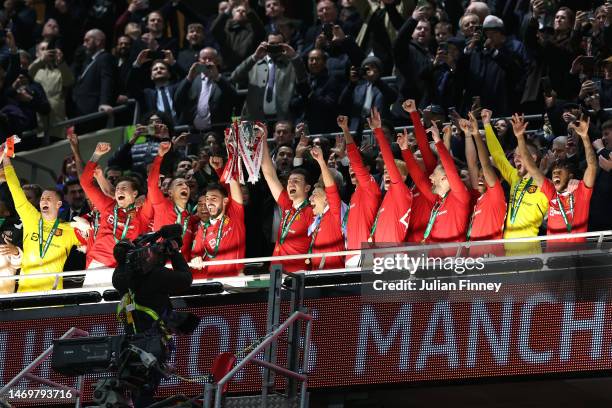 Bruno Fernandes and Harry Maguire of Manchester United lift the Carabao Cup trophy following victory in the Carabao Cup Final match between...