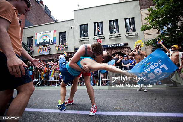 Revelers kiss in front of the Stonewall Inn during the New York City Gay Pride March on June 24, 2012 in New York City. The annual civil rights...