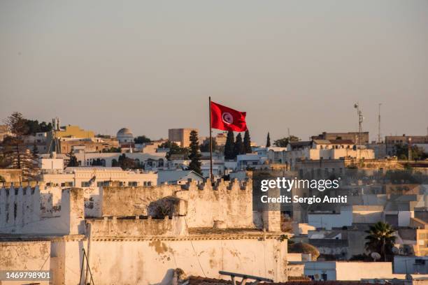 tunisian flag on medina building at sunset - tunis stock pictures, royalty-free photos & images