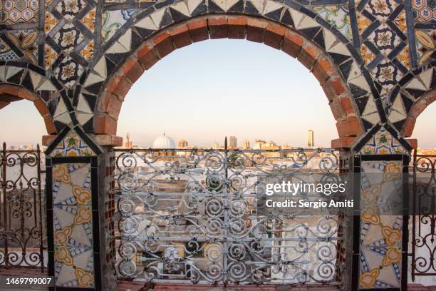 tunis medina at sunset seen through an arch decorated with ceramic tiles - tunisia mosque stock pictures, royalty-free photos & images