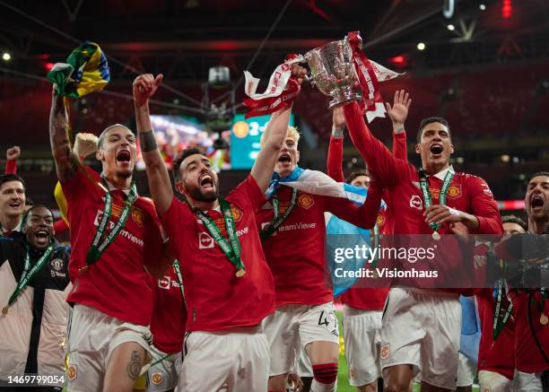 Manchester United players Antony, Bruno Fernandes, Alejandro Garnacho and Raphael Varane celebrate with the trophy after the Carabao Cup Final match...