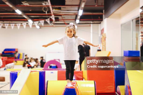 happy girl during corrective gymnastics - gymnastiek stockfoto's en -beelden