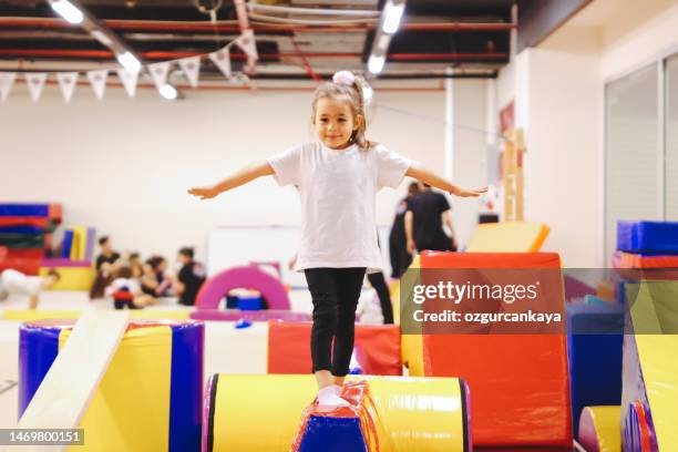 happy girl during corrective gymnastics - school gymnastics stock pictures, royalty-free photos & images