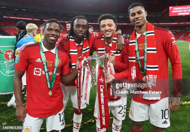 Tyrell Malacia, Aaron Wan-Bissaka, Jadon Sancho, Marcus Rashford of Manchester United celebrate with the trophy after the Carabao Cup Final match...