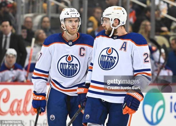 Leon Draisaitl of the Edmonton Oilers talks with Connor McDavid during a line change in the first period during the game against the Pittsburgh...