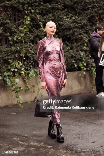 Guest is seen wearing pink and black pattern one piece and brown bag outside the Annakiki show during the Milan Fashion Week Womenswear Fall/Winter...