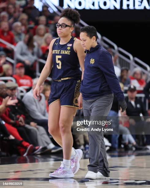 Olivia Myles of the Notre Dame Fighting Irish walks off of the court after being injured during the 68-65 win over the Louisville Cardinals against...