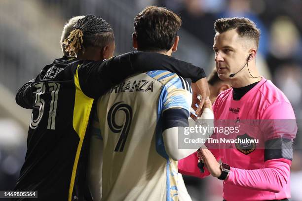 Referee Lukasz Szpala speaks with Steven Moreira of Columbus Crew and Julián Carranza of Philadelphia Union during the first half at Subaru Park on...