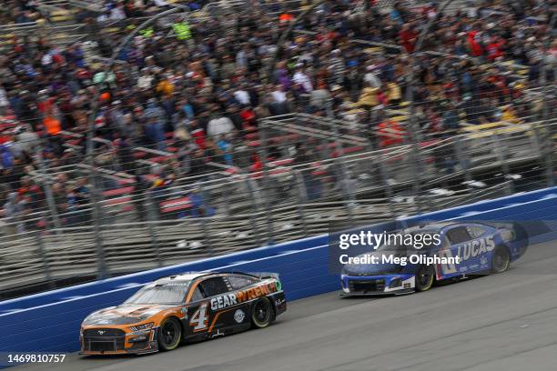 Kevin Harvick, driver of the GEARWRENCH Ford, and Kyle Busch, driver of the Lucas Oil Chevrolet, race during the NASCAR Cup Series Pala Casino 400 at...