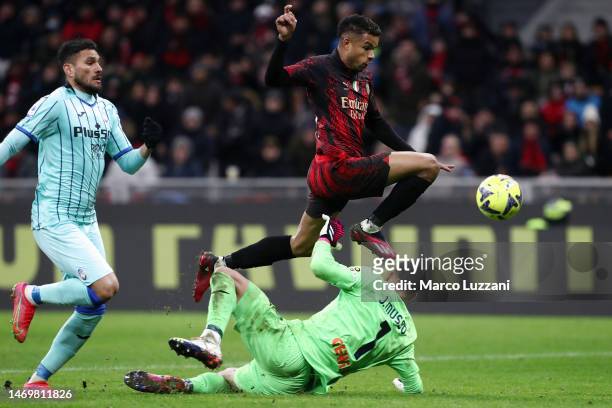 Junior Messias of AC Milan scores the team's second goal as Juan Musso of Atalanta BC attempts to make a save during the Serie A match between AC...