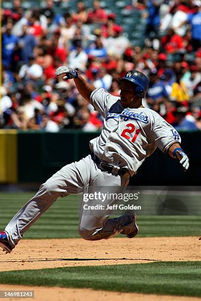 Juan Rivera of the Los Angeles Dodgers slides safely into second base on a double against the Los Angeles Angels of Anaheim to lead off the sixth...