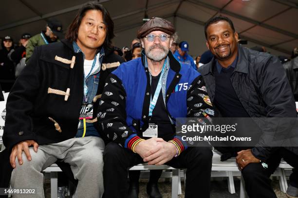 Sung Kang, Michael Rooker and Alfonso Ribeiro pose for photos during the drivers meeting prior to the NASCAR Cup Series Pala Casino 400 at Auto Club...