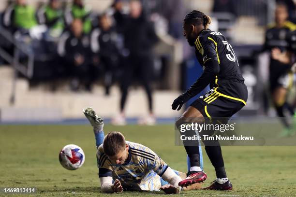 Mikael Uhre of Philadelphia Union is tackled by Steven Moreira of Columbus Crew at Subaru Park on February 25, 2023 in Chester, Pennsylvania.