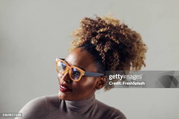 a happy beautiful businesswoman with blonde curly hair looking away - smart studio shot stock pictures, royalty-free photos & images