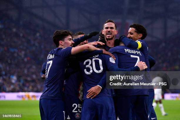 Leo Messi of Paris Saint-Germain is congratulated by teammates after scoring during the Ligue 1 match between Olympique Marseille and Paris...