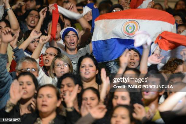 People demonstrate in front of the Paraguayan state-owned TV channel's headquarters in support of ousted Paraguayan President Fernando Lugo in...