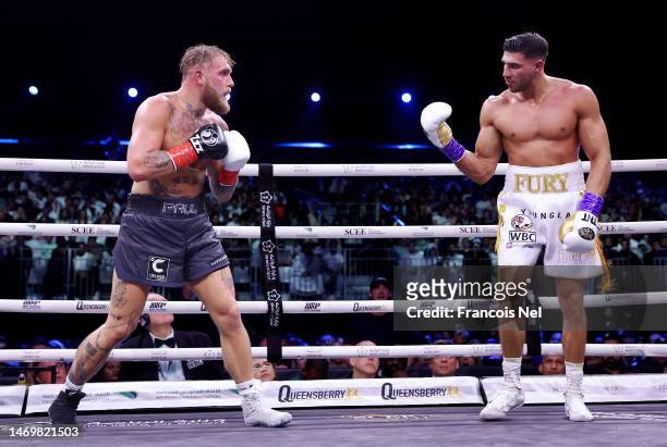 Jake Paul looks on as Tommy Fury taunts them during the Cruiserweight Title fight between Jake Paul and Tommy Fury at the Diriyah Arena on February...