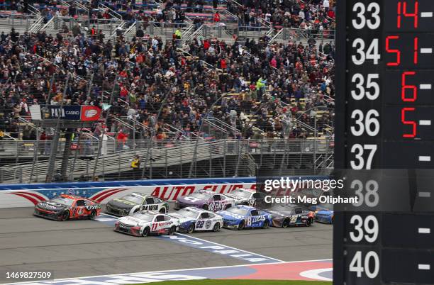 Ross Chastain, driver of the Kubota Chevrolet, leads the field to start stage two after winning stage one during the NASCAR Cup Series Pala Casino...