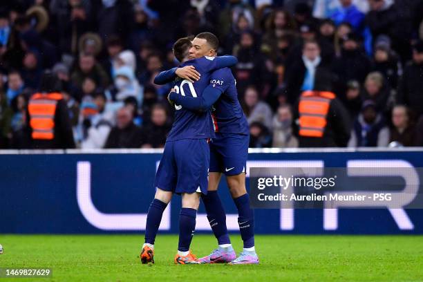 Kylian Mbappe of Paris Saint-Germain is congratulated by teammate Leo Messi after scoring during the Ligue 1 match between Olympique Marseille and...