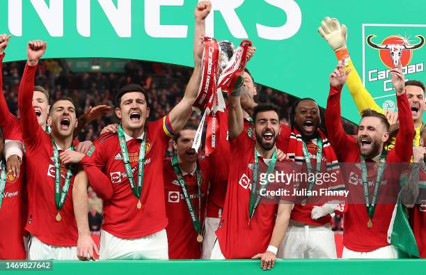 Bruno Fernandes and Harry Maguire of Manchester United lift the Carabao Cup trophy following victory in the Carabao Cup Final match between...