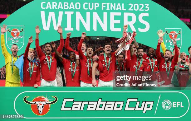 Bruno Fernandes and Harry Maguire of Manchester United lift the Carabao Cup trophy following victory in the Carabao Cup Final match between...