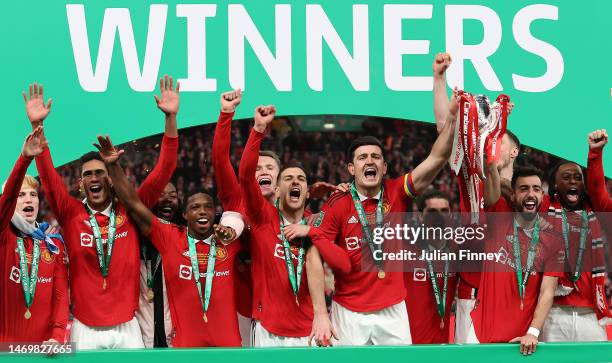 Bruno Fernandes and Harry Maguire of Manchester United lift the Carabao Cup trophy following victory in the Carabao Cup Final match between...