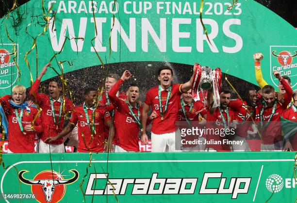 Bruno Fernandes and Harry Maguire of Manchester United lift the Carabao Cup trophy following victory in the Carabao Cup Final match between...