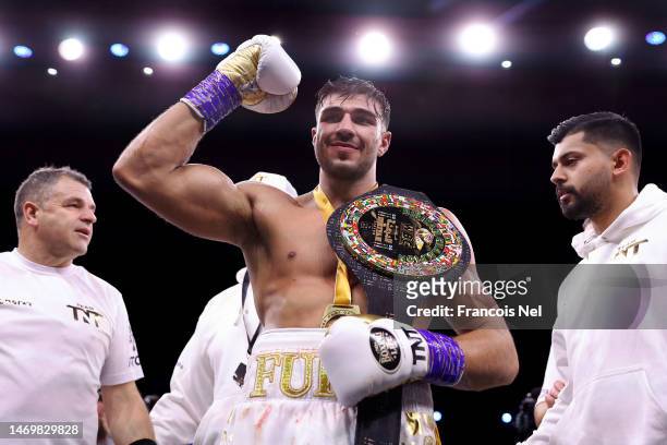 Tommy Fury poses for a photo with their Title Belt and coaching team after defeating Jake Paul during the Cruiserweight Title fight between Jake Paul...