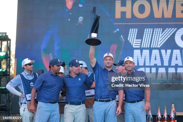 Anirban Lahiri, Paul Casey, Bryson DeChambeau and Charles Howell III celebrate with the trophy on the podium after winning the team award during day...