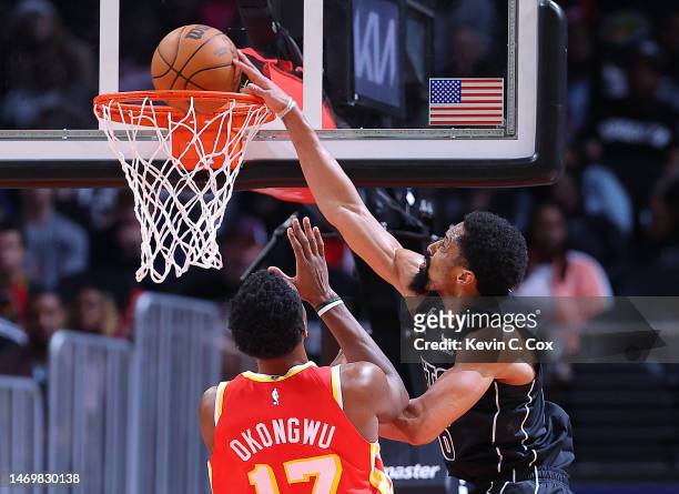 Spencer Dinwiddie of the Brooklyn Nets dunks against Onyeka Okongwu of the Atlanta Hawks during the fourth quarter at State Farm Arena on February...