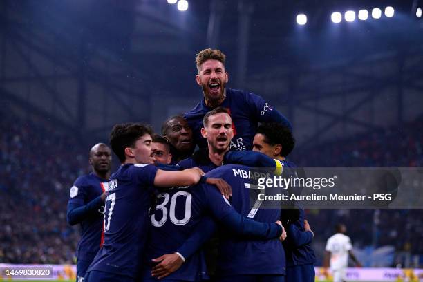 Leo Messi of Paris Saint-Germain is congratulated by teammates after scoring during the Ligue 1 match between Olympique Marseille and Paris...