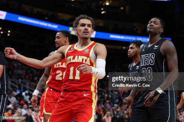 Trae Young of the Atlanta Hawks reacts after a basket against the Brooklyn Nets during the fourth quarter at State Farm Arena on February 26, 2023 in...