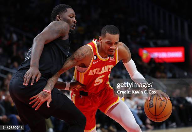 Dejounte Murray of the Atlanta Hawks drives against Dorian Finney-Smith of the Brooklyn Nets during the fourth quarter at State Farm Arena on...