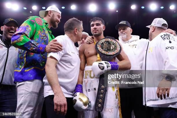 Tommy Fury celebrates as they pose for a photo with their Title Belt, coaching team, brother Boxer Tyson Fury and Father John Fury after defeating...