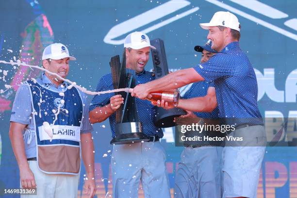 Anirban Lahiri, Paul Casey, Bryson DeChambeau and Charles Howell III and caddies of Crushers GC celebrate with the trophy on the podium after winning...
