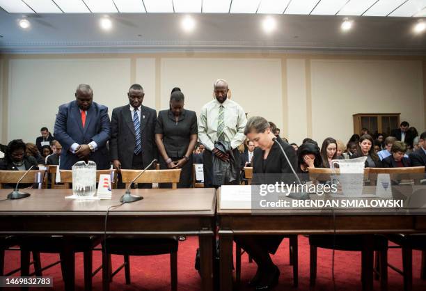 Sybrina Fulton and Tracy Martin , parents of Trayvon Martin, bow their heads for a moment of silence with their friend and lawyer Benjamin Crump and...