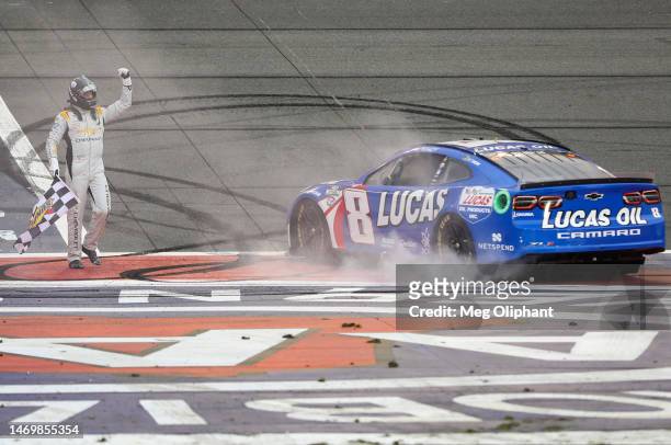 Kyle Busch, driver of the Lucas Oil Chevrolet, celebrates with the checkered flag after winning the NASCAR Cup Series Pala Casino 400 at Auto Club...