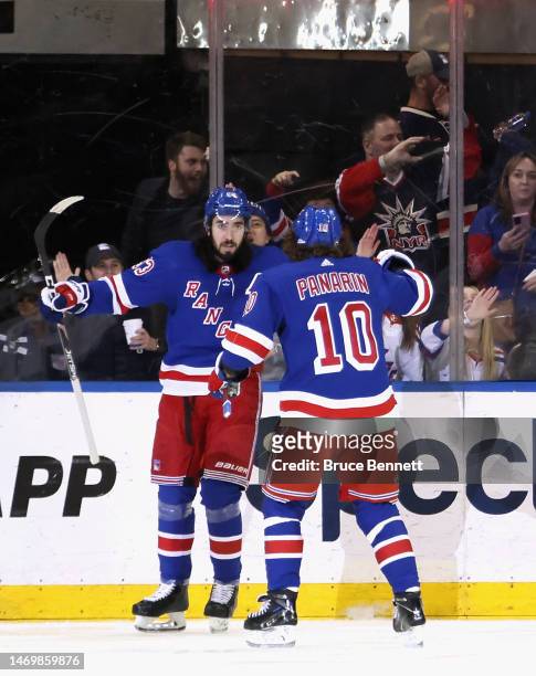 Mika Zibanejad of the New York Rangers celebrates his powerplay goal at 5:26 of the third period against the Los Angeles Kings and is joined by...