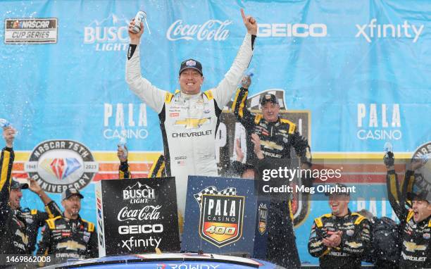 Kyle Busch, driver of the Lucas Oil Chevrolet, celebrates in victory lane after winning the NASCAR Cup Series Pala Casino 400 at Auto Club Speedway...