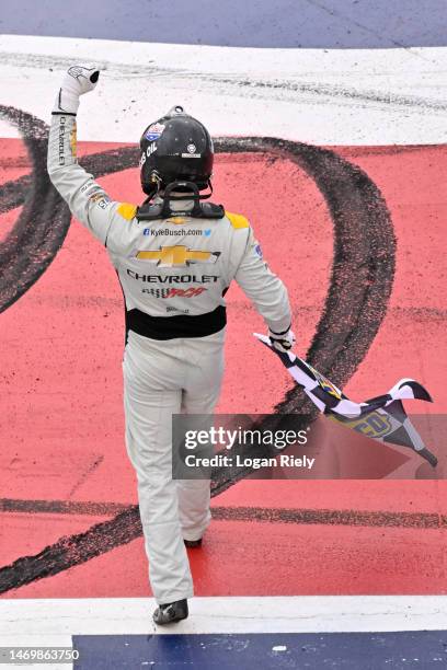 Kyle Busch, driver of the Lucas Oil Chevrolet, celebrates with the checkered flag after winning the NASCAR Cup Series Pala Casino 400 at Auto Club...