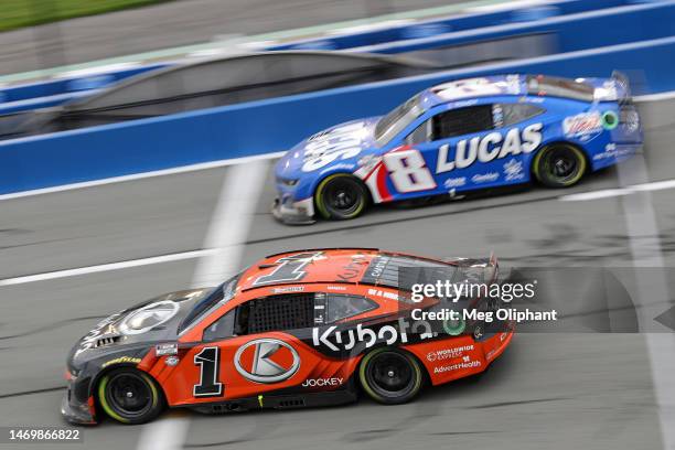 Ross Chastain, driver of the Kubota Chevrolet, and Kyle Busch, driver of the Lucas Oil Chevrolet, race off pit road during the NASCAR Cup Series Pala...