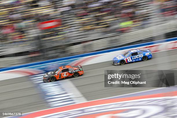 Ross Chastain, driver of the Kubota Chevrolet, and Kyle Busch, driver of the Lucas Oil Chevrolet, race during the NASCAR Cup Series Pala Casino 400...