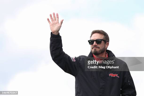 Yeley, driver of the ActOne Group Ford, waves to fans as he walks onstage during driver intros prior to the NASCAR Cup Series Pala Casino 400 at Auto...