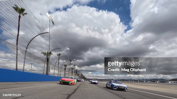 Christopher Bell, driver of the Sirius XM Toyota, and Ricky Stenhouse Jr, driver of the Ralphs/Tree Top Chevrolet, lead the field on a pace lap prior...