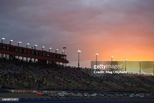General view of racing as the sun sets during the NASCAR Xfinity Series Production Alliance Group 300 at Auto Club Speedway on February 26, 2023 in...