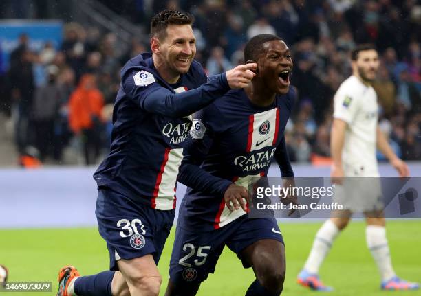 Lionel Messi of PSG celebrates his goal with Nuno Mendes during the Ligue 1 match between Olympique de Marseille and Paris Saint-Germain at Stade...