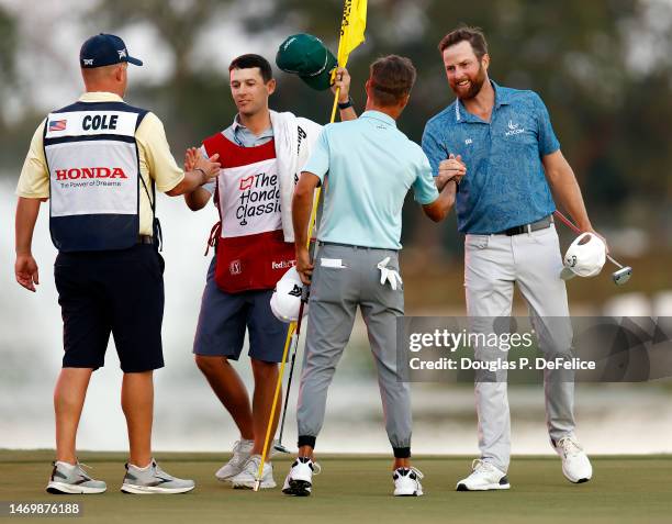 Chris Kirk of the United States is congratulated by runner-up Eric Cole of the United States on the 18th hole after winning the The Honda Classic at...