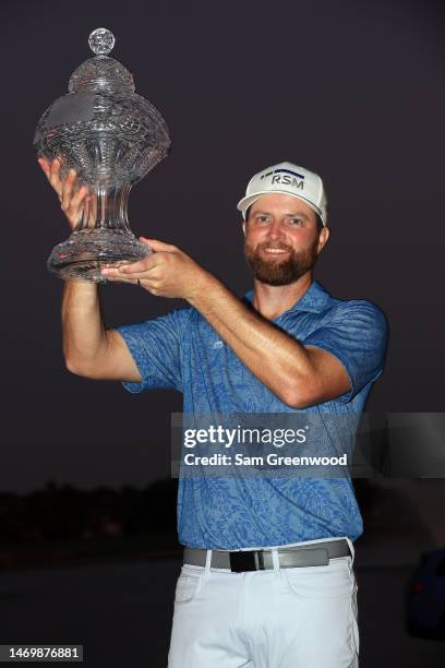 Chris Kirk of the United States stands with the trophy after winning The Honda Classic in a playoff at PGA National Resort And Spa on February 26,...