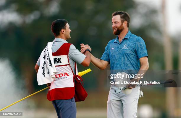 Chris Kirk of the United States is congratulated by his caddie on the 18th hole after winning the The Honda Classic in a playoff at PGA National...