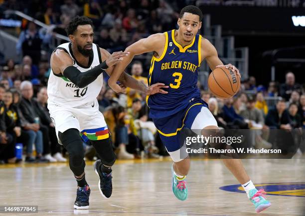 Jordan Poole of the Golden State Warriors drives towards the basket past Mike Conley of the Minnesota Timberwolves during the fourth quarter at Chase...